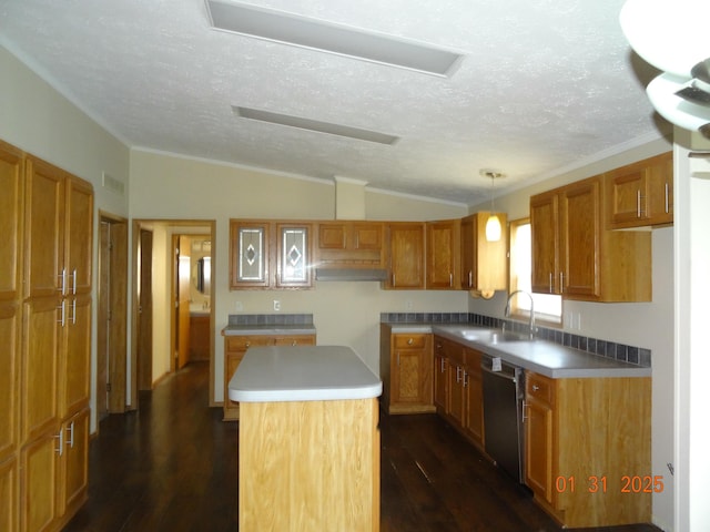 kitchen featuring lofted ceiling, sink, hanging light fixtures, dishwasher, and a kitchen island