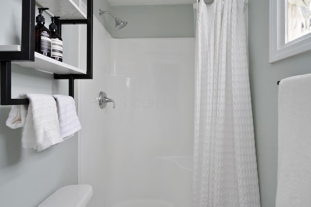 bathroom featuring a shower with curtain