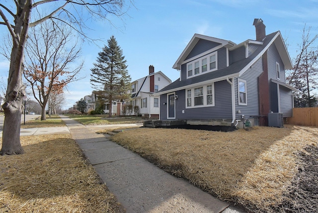 view of front facade with central AC and a front yard