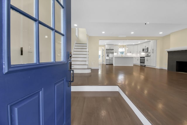 foyer featuring dark hardwood / wood-style floors and a notable chandelier