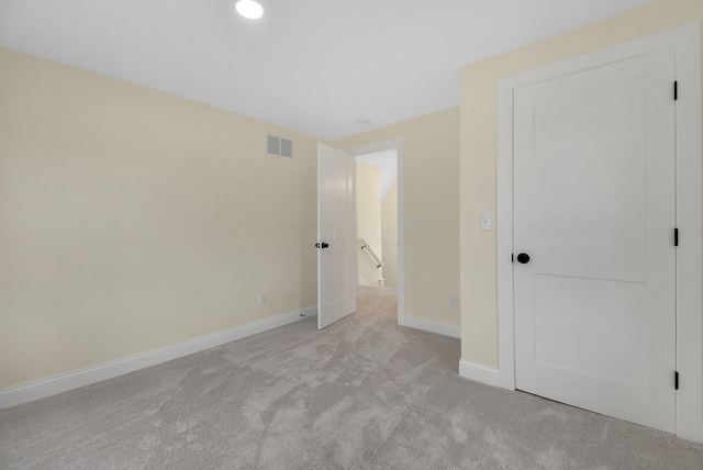 unfurnished bedroom featuring light carpet