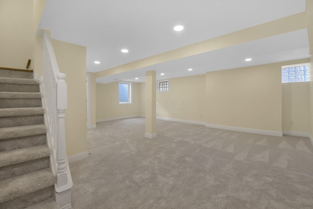 basement with plenty of natural light and light carpet