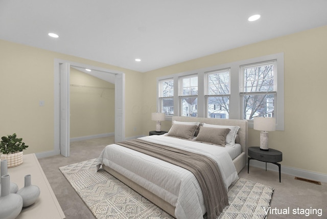 carpeted bedroom with a closet and multiple windows