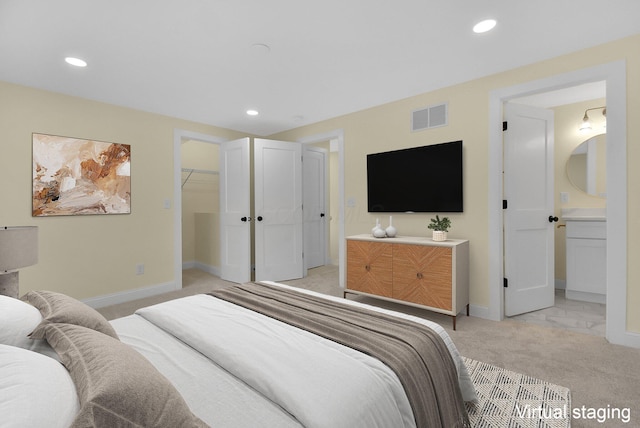 carpeted bedroom featuring a walk in closet