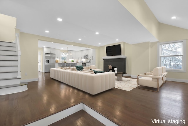 living room with hardwood / wood-style flooring and vaulted ceiling