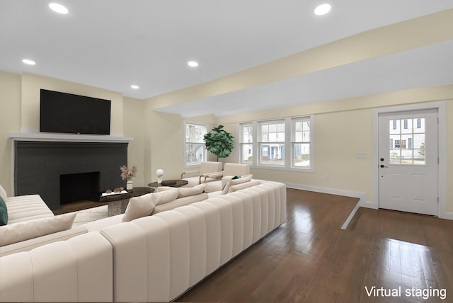 living room with a wealth of natural light and dark hardwood / wood-style floors