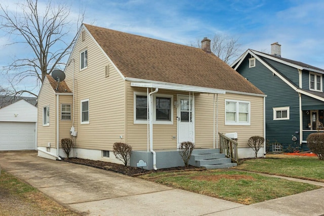 view of front of property featuring a garage, an outdoor structure, and a front yard