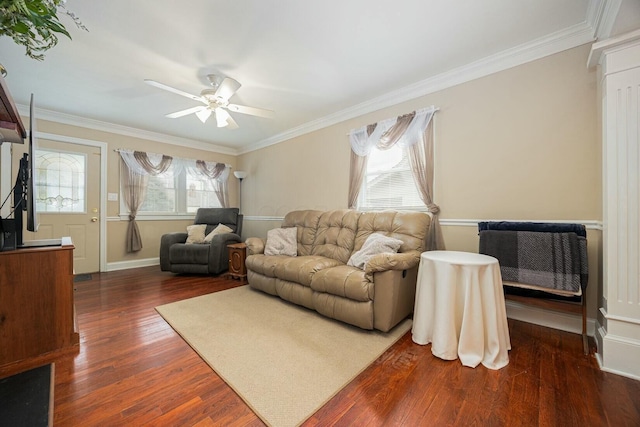 living room with dark wood-type flooring, ceiling fan, ornamental molding, and ornate columns