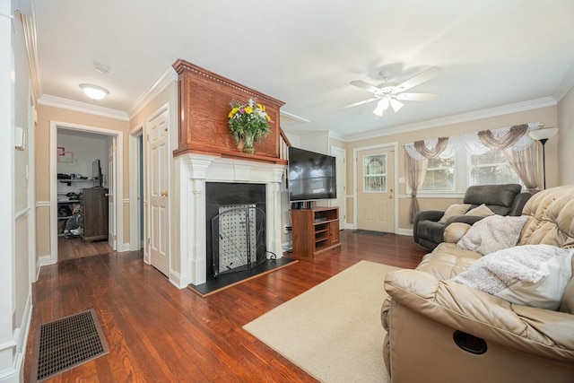 living room featuring dark wood-type flooring, ceiling fan, and crown molding