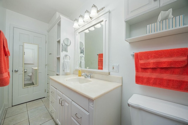 bathroom featuring tile patterned flooring, vanity, and toilet