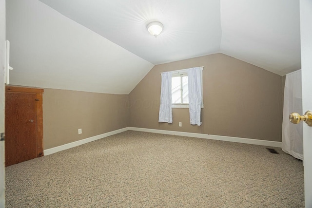 additional living space with lofted ceiling and carpet floors