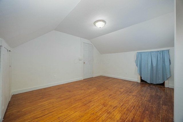 bonus room featuring dark hardwood / wood-style flooring and vaulted ceiling