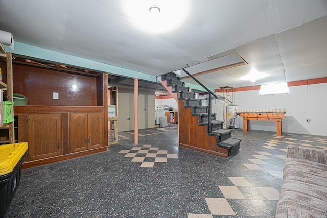 basement with water heater and washer / clothes dryer