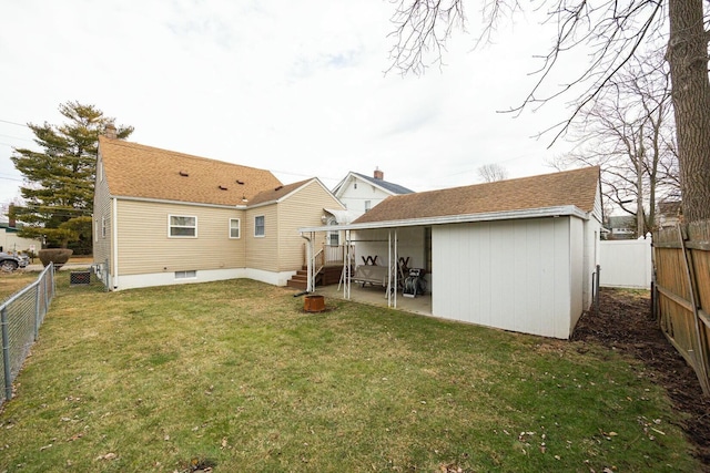 rear view of property with a yard and a patio area