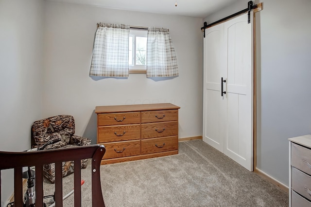 carpeted bedroom with a barn door