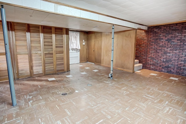 basement with brick wall and wood walls