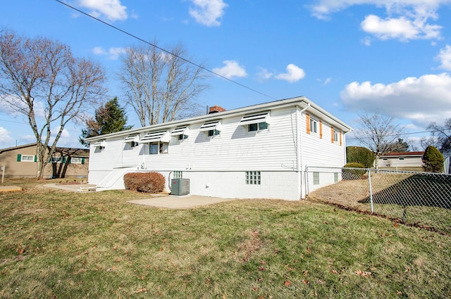 back of house featuring central AC, a lawn, and a patio