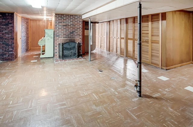 basement featuring a fireplace and wood walls