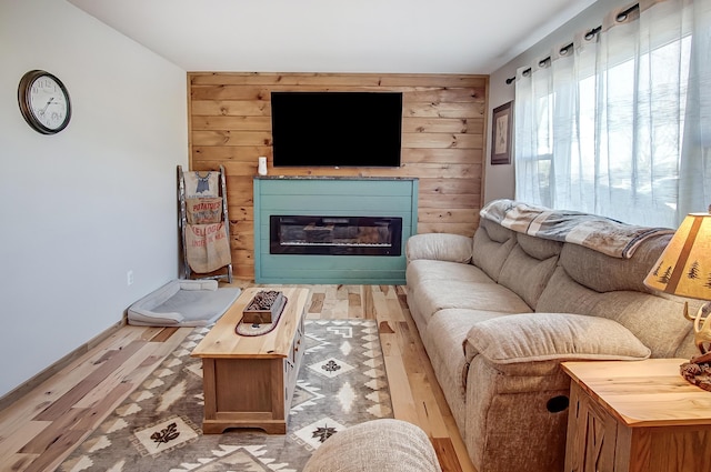 living room featuring light hardwood / wood-style floors and wood walls