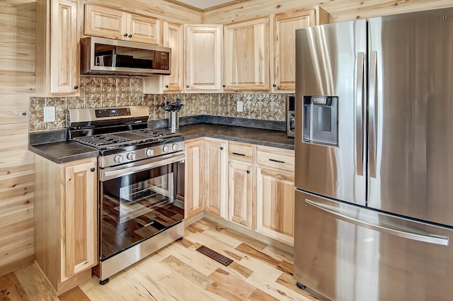 kitchen featuring tasteful backsplash and stainless steel appliances