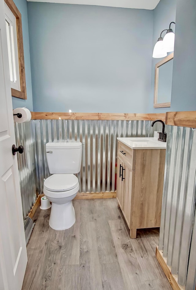 bathroom featuring hardwood / wood-style flooring, vanity, and toilet