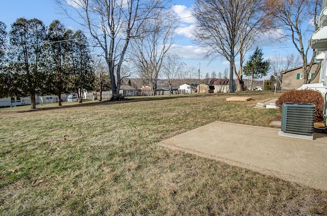 view of yard featuring central AC and a patio