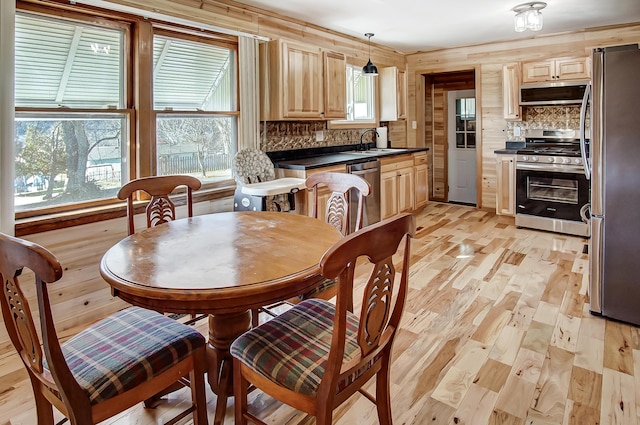 dining room with sink and light hardwood / wood-style flooring