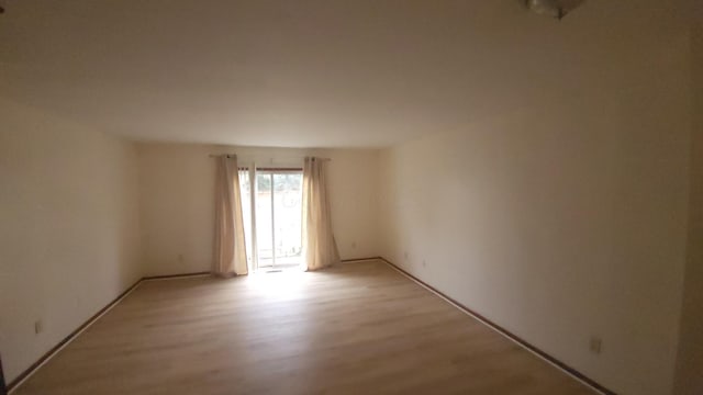 spare room with light hardwood / wood-style flooring