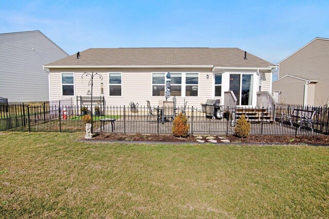 back of house with a lawn