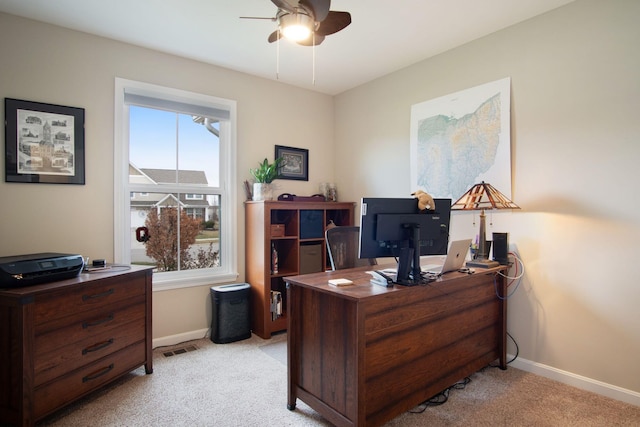 carpeted home office with ceiling fan