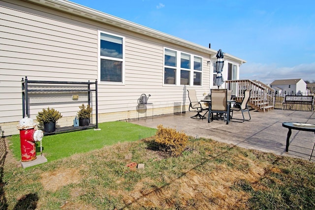 back of property with a yard and a patio area