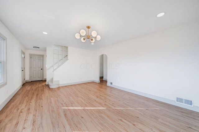 interior space with an inviting chandelier and light hardwood / wood-style floors