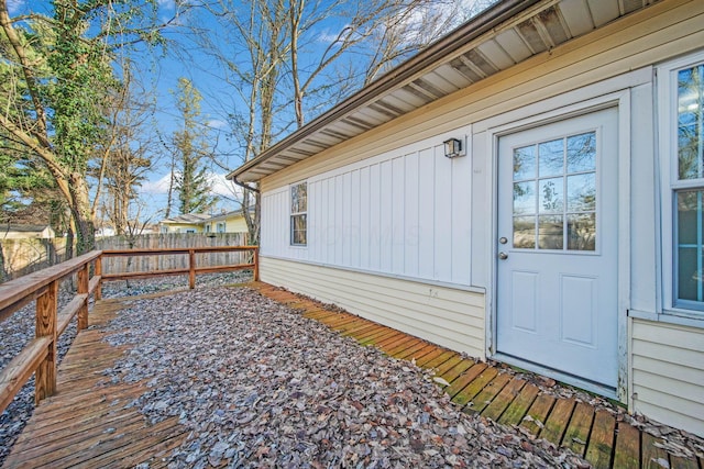 view of exterior entry featuring a wooden deck