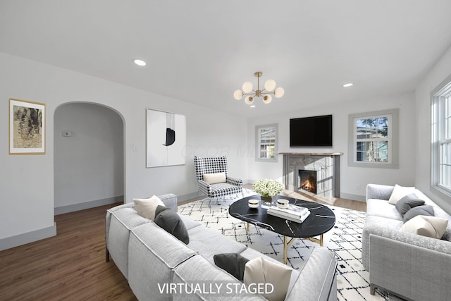 living room with wood-type flooring and a chandelier