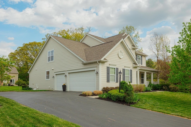 view of front of property featuring a garage and a front yard