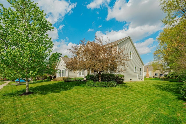 back of property featuring a lawn