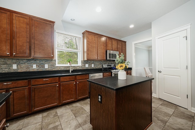 kitchen with sink, decorative backsplash, a kitchen island, and appliances with stainless steel finishes