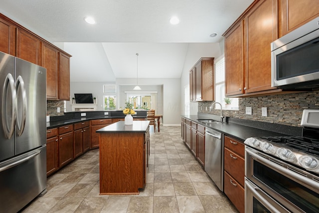 kitchen featuring vaulted ceiling, sink, decorative backsplash, a center island, and stainless steel appliances