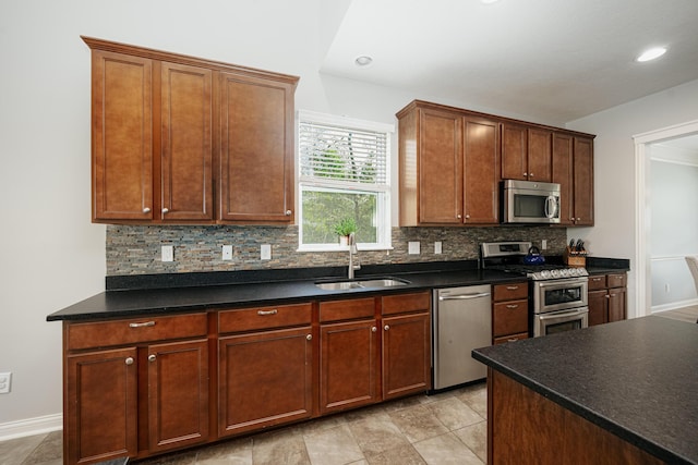 kitchen featuring stainless steel appliances, tasteful backsplash, and sink