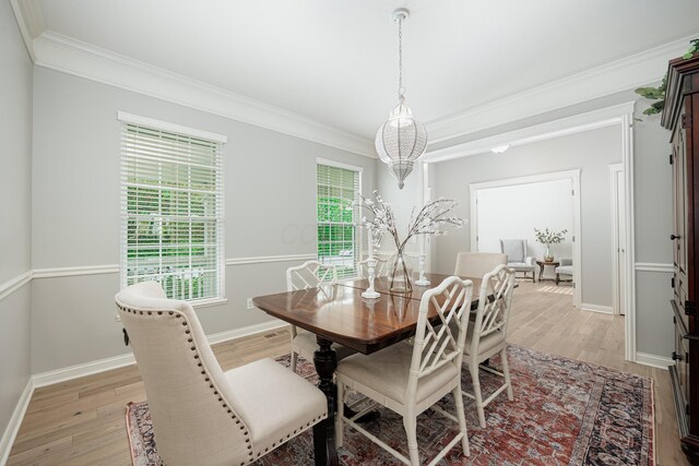 dining area featuring crown molding and light hardwood / wood-style floors