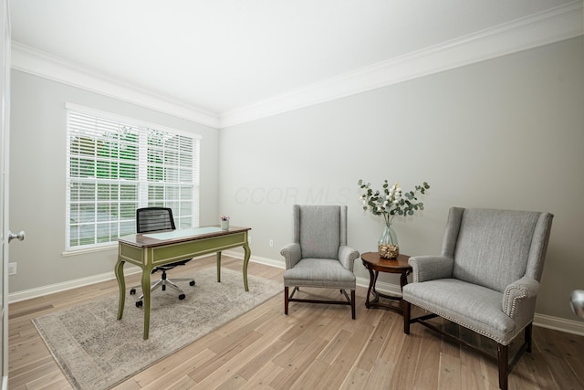 office space with ornamental molding and light hardwood / wood-style floors