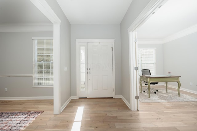 foyer featuring light hardwood / wood-style flooring and ornamental molding