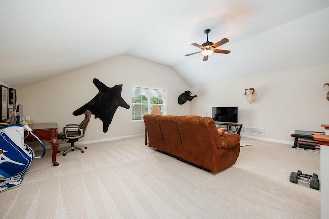 carpeted living room with ceiling fan and vaulted ceiling