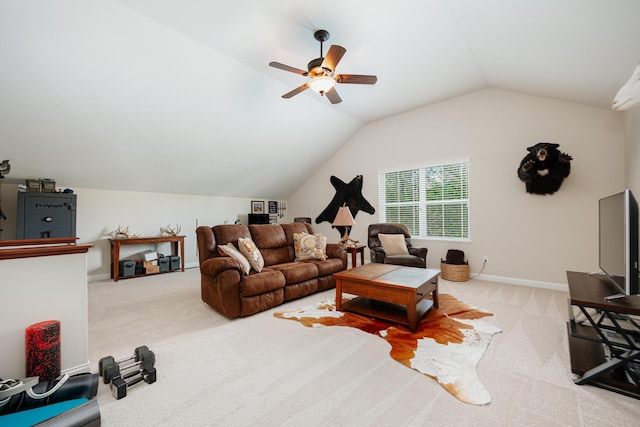 living room featuring ceiling fan, lofted ceiling, and carpet flooring