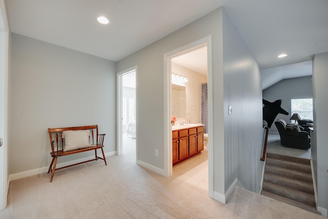 corridor with light carpet and sink