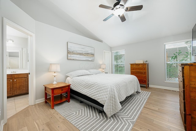 bedroom with multiple windows, vaulted ceiling, and light hardwood / wood-style floors