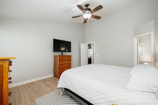 bedroom featuring lofted ceiling, ceiling fan, and light hardwood / wood-style flooring