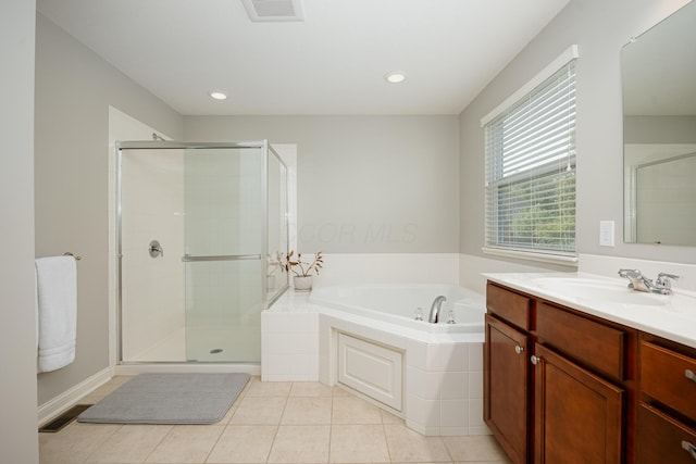 bathroom with tile patterned floors, shower with separate bathtub, and vanity