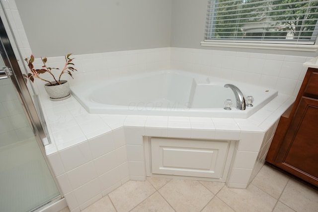 bathroom featuring tile patterned flooring, vanity, and a shower with shower door