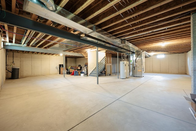 basement featuring water heater and heating unit